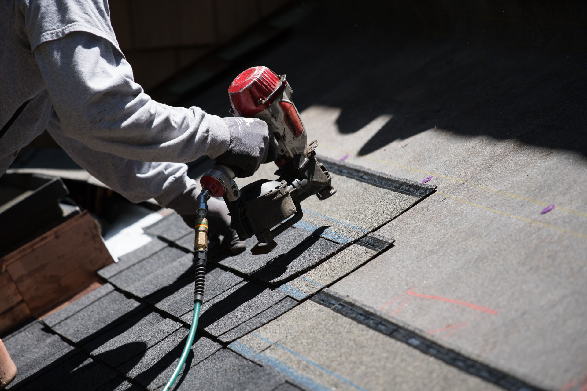 Installing new roof with nail gun